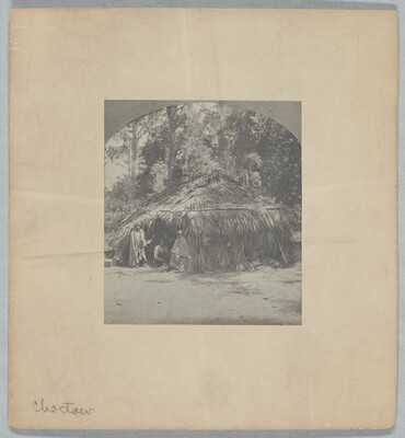 A black-and-white photograph of a wigwam with three figures in the doorway.