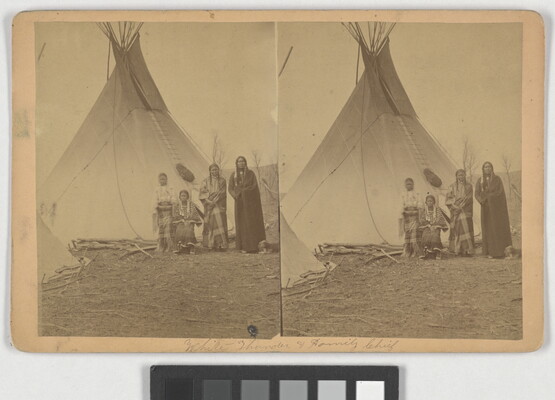 A sepia-toned stereograph of a Native American family standing in front of a tipi.