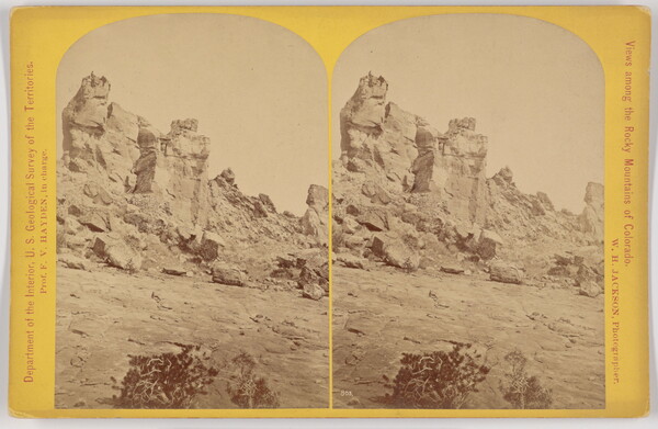 Two almost identical side-by-side sepia-toned photographs of a tall rock formation.