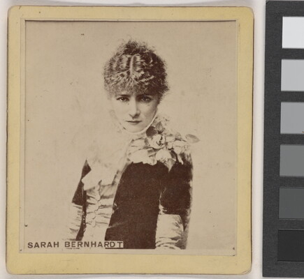 A sepia-toned portrait photograph of a young, White woman from the waist up, wearing formal, early 20th century clothing.