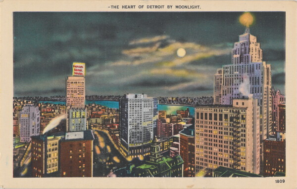 A color photograph postcard of a riverside city at night, buildings lit up, and the moon shining through dark clouds.