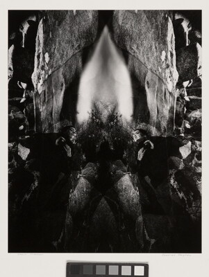 An abstract black-and-white photograph of rock formations, waterfalls, and other natural materials reflected to create a symmetrical design.