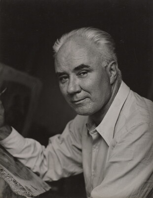 A black-and-white photograph of a middle-aged White man in three-quarter view leaning on something in front of him with his forearm.
