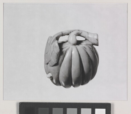 A black-and-white photograph of a ceramic pumpkin.