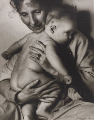 A black-and-white photograph of a White woman holding a naked baby to her chest.