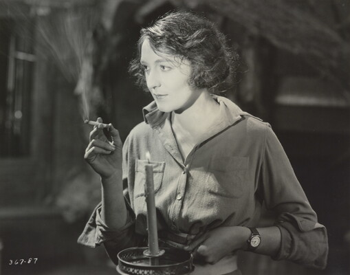 [Dorothy Cumming smoking cigarette and holding candle, 