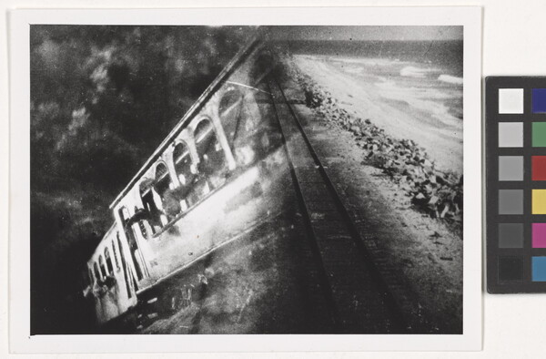 A black-and-white photograph of a train car overlayed with a photograph of train tracks.