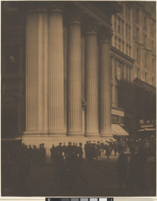 A sepia-toned photograph of people walking in front of a tall white city building with large fluted columns.