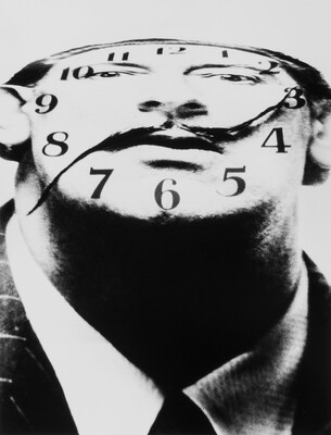 A black-and-white photograph of a White man's distorted face as a clock face with his mustache as the hands.