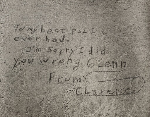 A black-and-white photograph of a note written on what looks like a cement wall that reads: "To my best pal I ever had. I'm sorry I did you wrong Glenn. From Clarence."