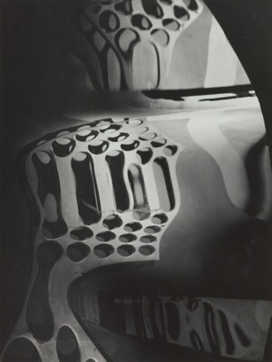 A black-and-white photograph of circular shapes distorted by a wavy mirror.