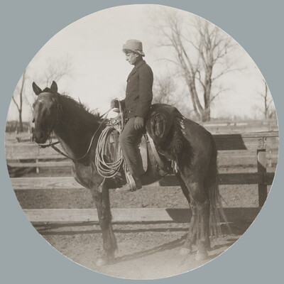 A circular black-and-white photograph of a White man on horseback in profile.