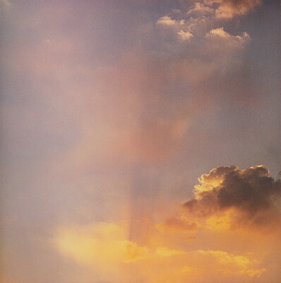 A color photograph of gold and rose clouds at sunset.