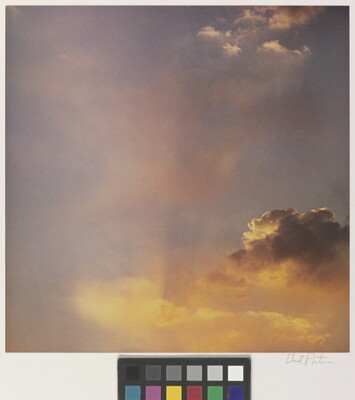 A color photograph of gold and rose clouds at sunset.