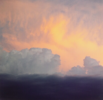 A color photograph of clouds: dark at the bottom, billowing white clouds in the middle, and soft gold and orange clouds at the top.