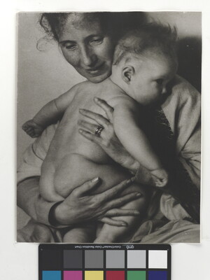 A black-and-white photograph of a White woman holding a naked baby to her chest.