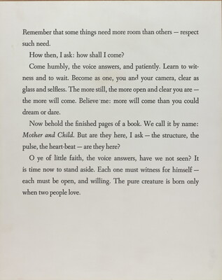 A black-and-white photograph of a white page with four paragraphs of black text.