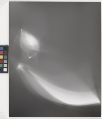An abstract black-and-white photograph of foggy, white shapes against a black background.