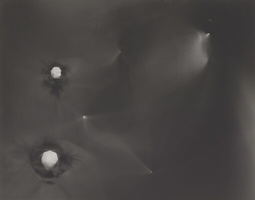An abstract black-and-white photograph of foggy star-like constellations against a black background.