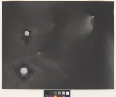 An abstract black-and-white photograph of foggy star-like constellations against a black background.