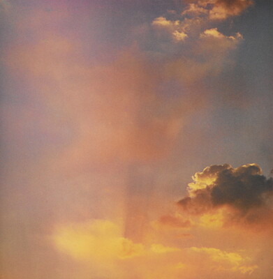 A color photograph of gold and rose clouds at sunset.