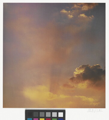 A color photograph of gold and rose clouds at sunset.