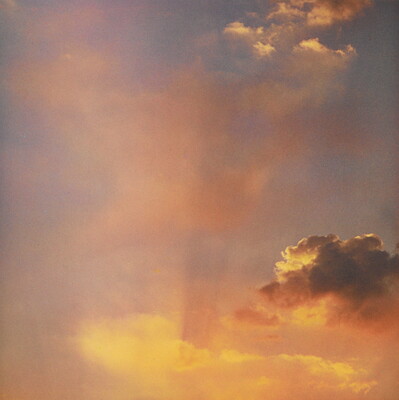 A color photograph of gold and rose clouds at sunset.