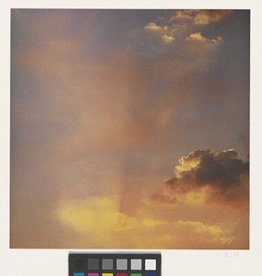 A color photograph of gold and rose clouds at sunset.