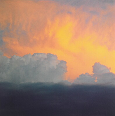 A color photograph of clouds: dark at the bottom, billowing white clouds in the middle, and soft gold and orange clouds at the top.