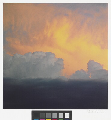 A color photograph of clouds: dark at the bottom, billowing white clouds in the middle, and soft gold and orange clouds at the top.