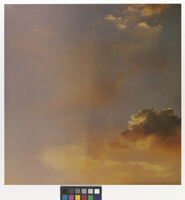 A color photograph of gold and rose clouds at sunset.