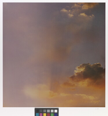 A color photograph of gold and rose clouds at sunset.