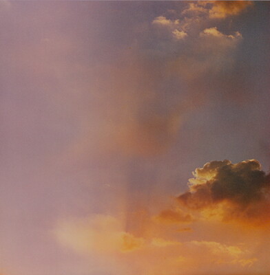 A color photograph of gold and rose clouds at sunset.