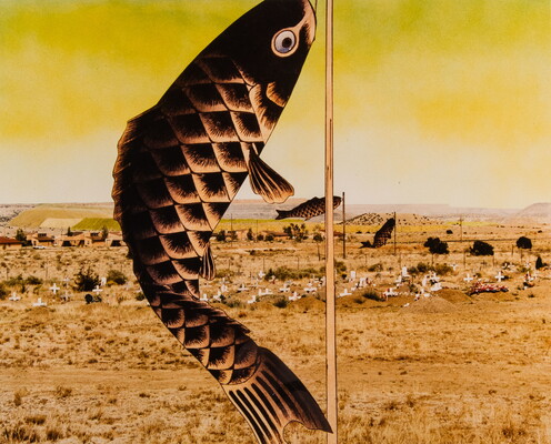 A color photograph of Japanese carp banners hanging from poles, receding into a distant, flat landscape full of white crosses under a glowing yellow sky.
