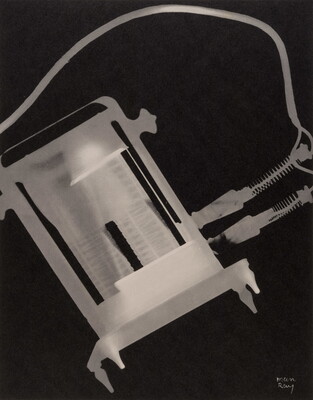 An abstract black-and-white photograph of a white and gray X-ray-like silhouette of a toaster and its electric cords.