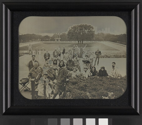 A black-and-white photograph of a group of people posing on the plaza in front of the Carter.