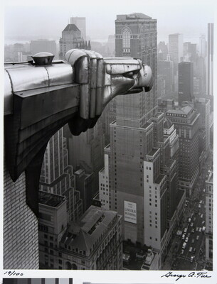 A black-and-white photograph of an Art-Deco gargoyle of an eagle overlooking the New York cityscape.