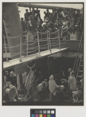A black-and-white photograph of people outside on two decks of a crowded ship.