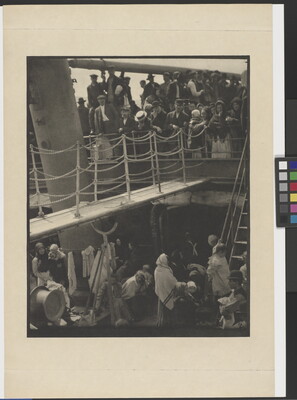 A black-and-white photograph of people outside on two decks of a crowded ship.