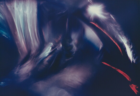 An abstract color photograph of blue, white, and pink light streaks; two diagonal red steaks on the right side.