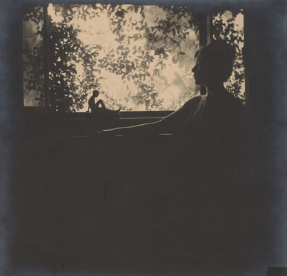 A black-and-white photograph of a silhouette of a woman in profile in front of a garden window.