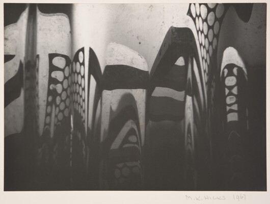An abstract black-and-white photograph of circle patterns and blocky shadows.