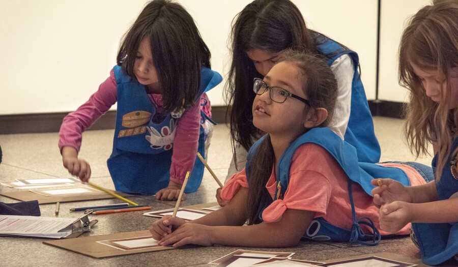 Four Daisy Scouts working on an art project at the Carter.