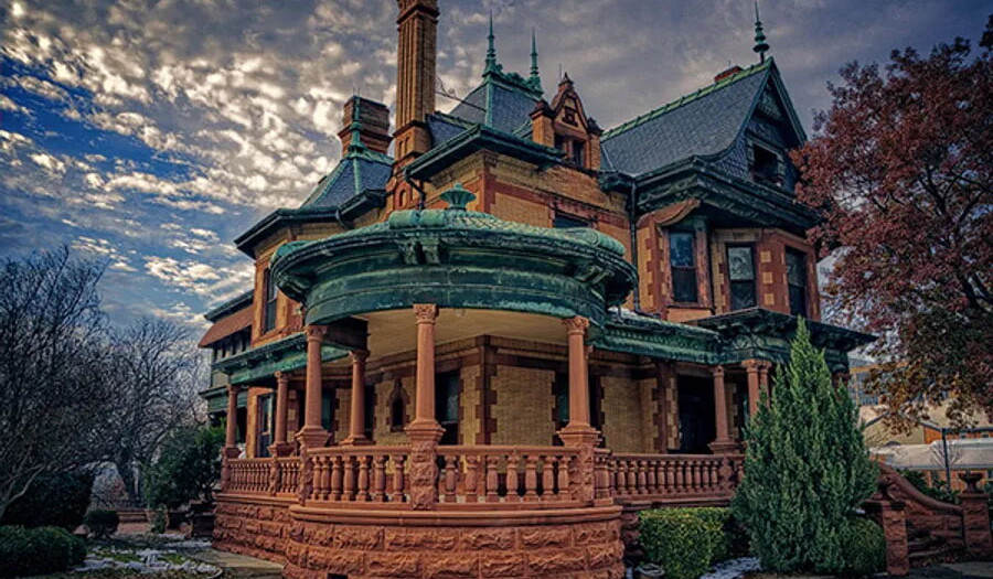 A Victorian "painted lady" style house with a huge wrap-around porch.