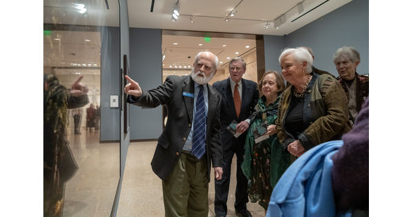 Older adults stand in front of artwork at the Carter.