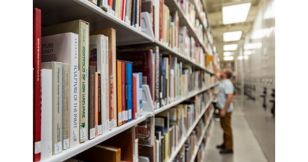 A person looks at books on a shelf in the Carter library.