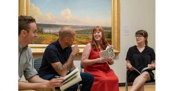 A group of people reading a book in one of the Carter&#039;s galleries.