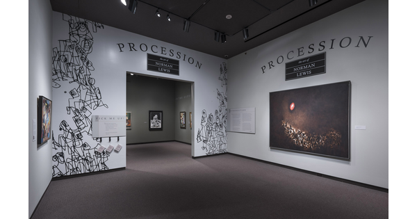 White title wall for Procession exhibition shows black &quot;scribbles&quot; around an entryway. To the right is a large abstract painting featuring geometric shapes on the bottom of the dark canvas and a red and white circle in the upper left.