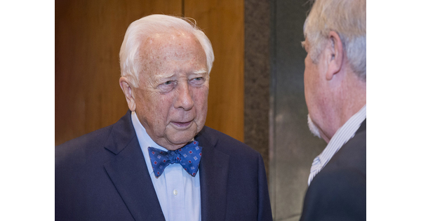 Author David McCullough talks to a person who is mostly cropped from the photo.