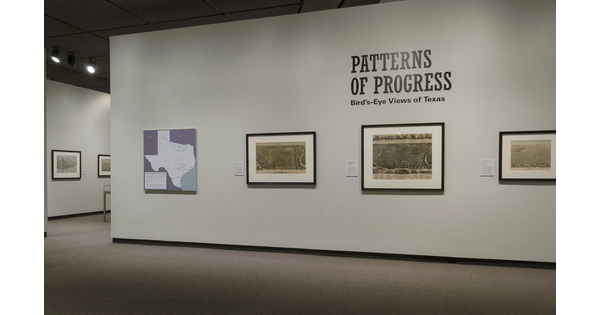 Cream-colored title wall with a map of Texas on the far left, then three framed detailed maps.